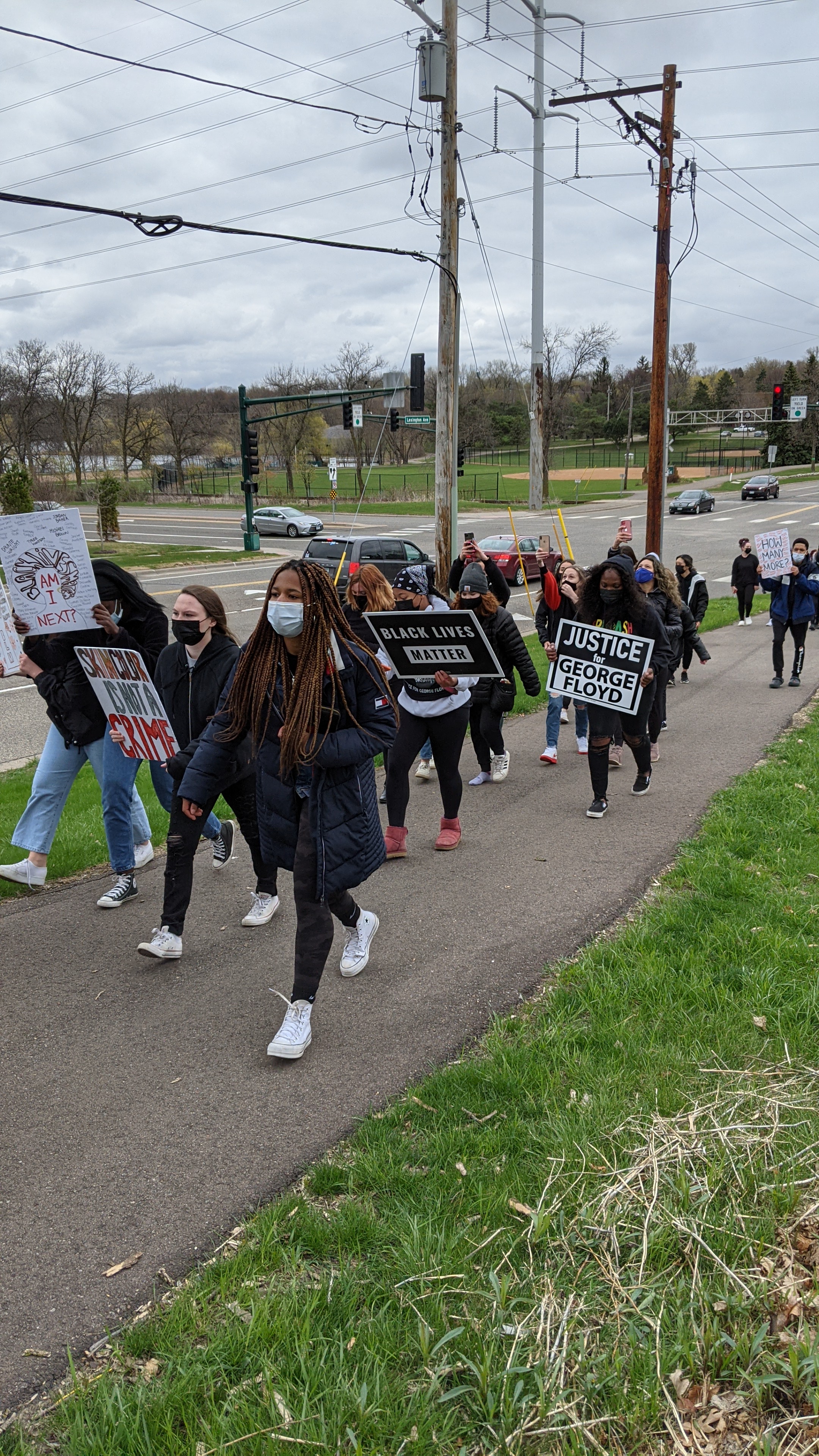 Students walk towards the police station